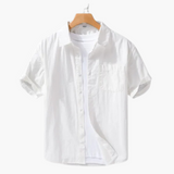 Camisa branca de manga curta, referência de estilo aristocrático e leveza.