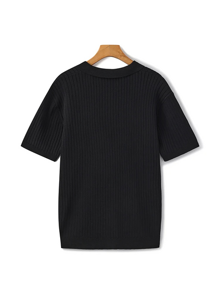 Polo preta de seda gelada com textura vertical e gola clássica. Sofisticação e frescor no mesmo visual.